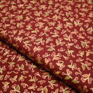 Tela en fondo rojo con motivos de navidad