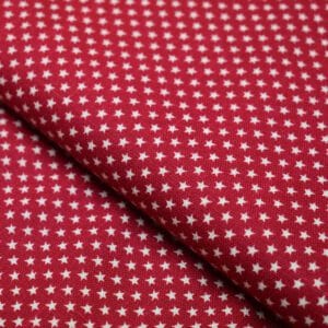 Tela topo estrellas blancas con fondo rojo.  John Louden